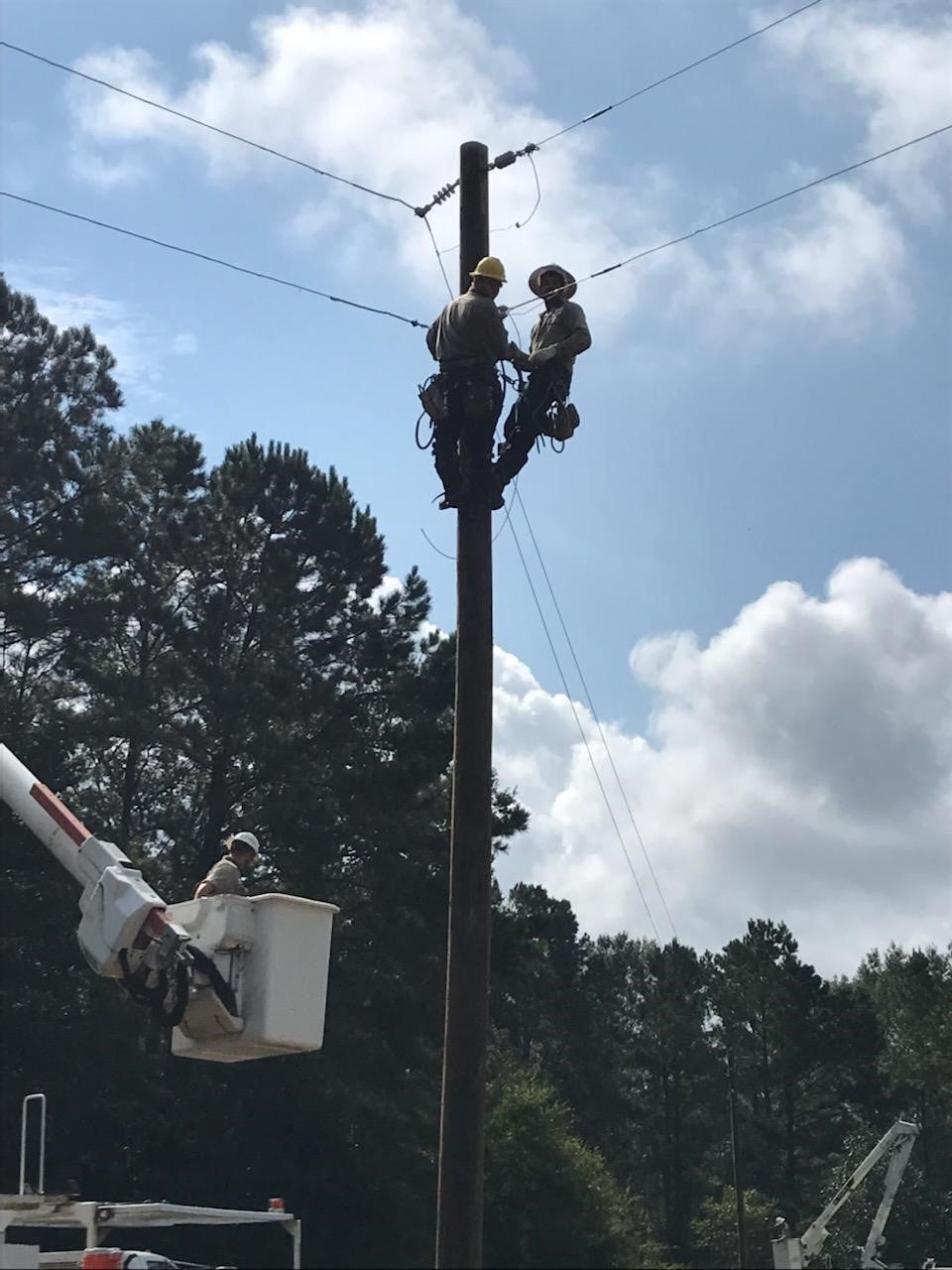 Workers on Pole Repairing Power Lines